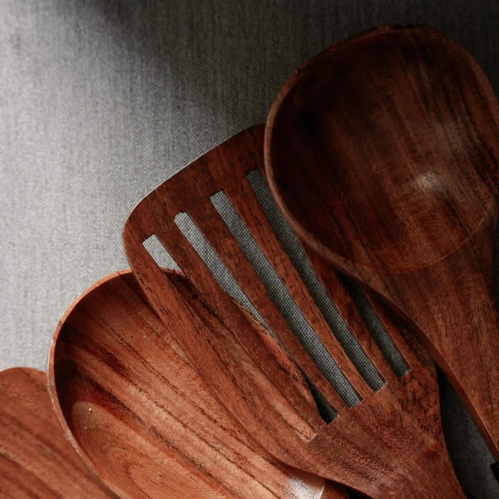 Close-up of Nordico wooden kitchen utensils showing rich wood grain texture and smooth finish.