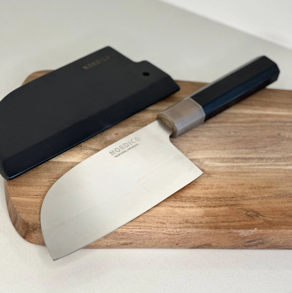 The Nordico VG10 cleaver knife unsheathed, showcasing its polished blade and ergonomic black pakkawood handle with buffalo horn detail.