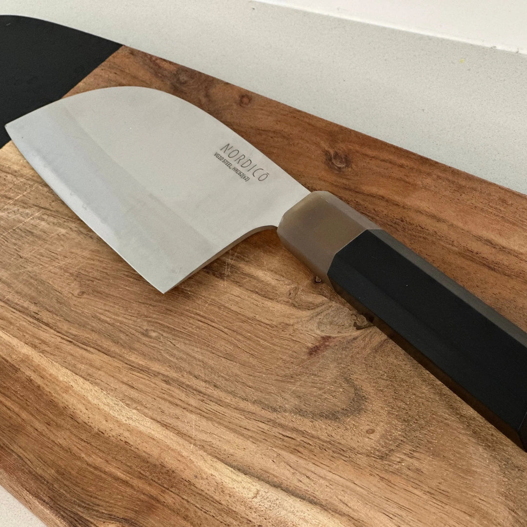 Close-up of the Nordico VG10 cleaver knife's blade, emphasizing its precision Japanese steel and minimalist mirror pattern.