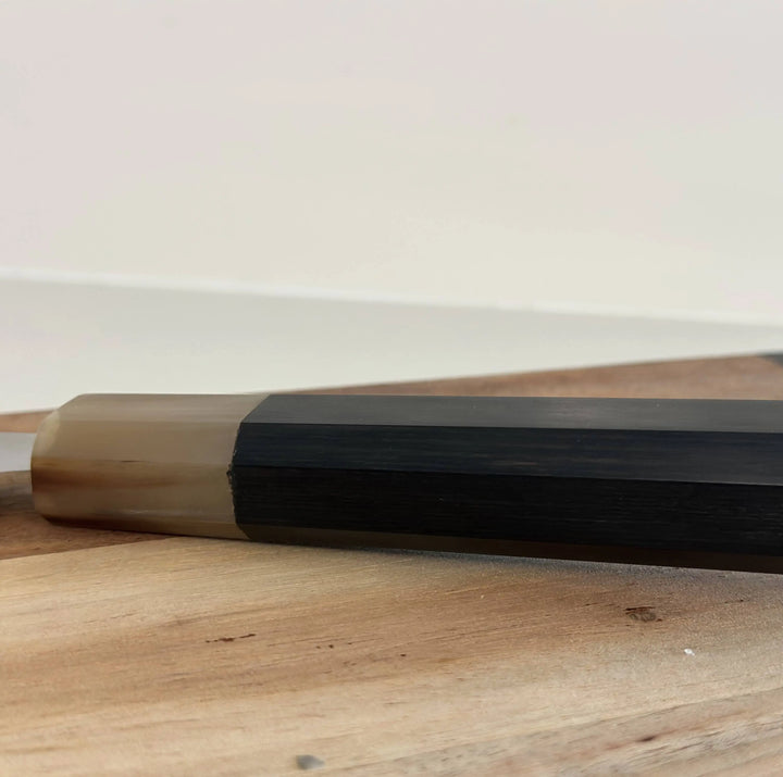 Close-up view of the Nordico VG10 Paring Knife handle made of black Pakkawood with a unique buffalo horn design.