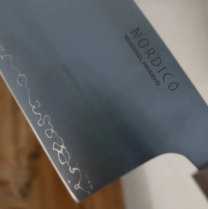 Blade of the Nordico VG10 Paring Knife with intricate hollow grind pattern and Nordico logo etched on the blade.
