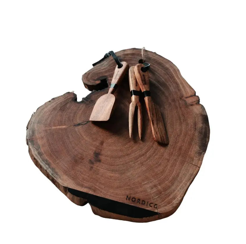 Side Angle of Nordico Cheese Board Set – Nordico wooden cheese board with three accompanying cheese knives placed stylishly, emphasizing its craftsmanship and durability.