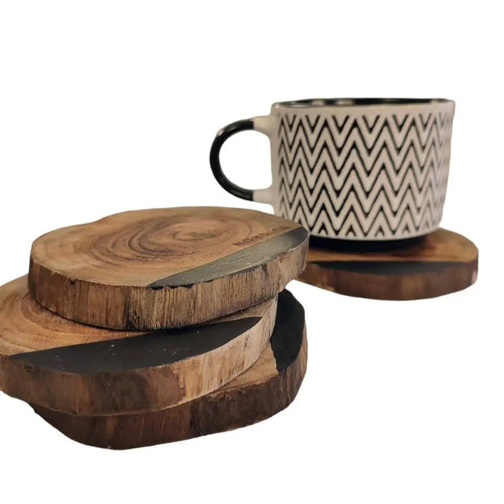 NORDICO Acacia wooden coasters set displayed with a patterned ceramic coffee cup, highlighting their natural and durable design.