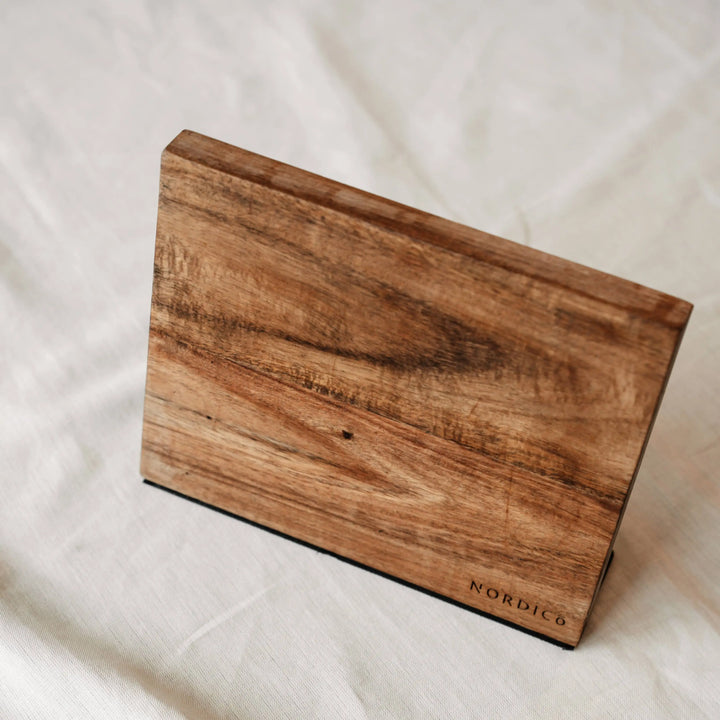 Close-up of the Nordico magnetic knife block highlighting its acacia wood grain and craftsmanship.