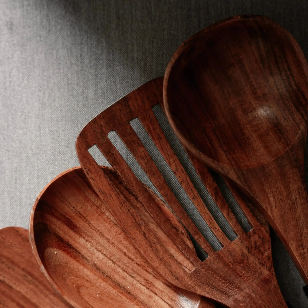 Close-up of Nordico wooden kitchen utensils showing rich wood grain texture and smooth finish.