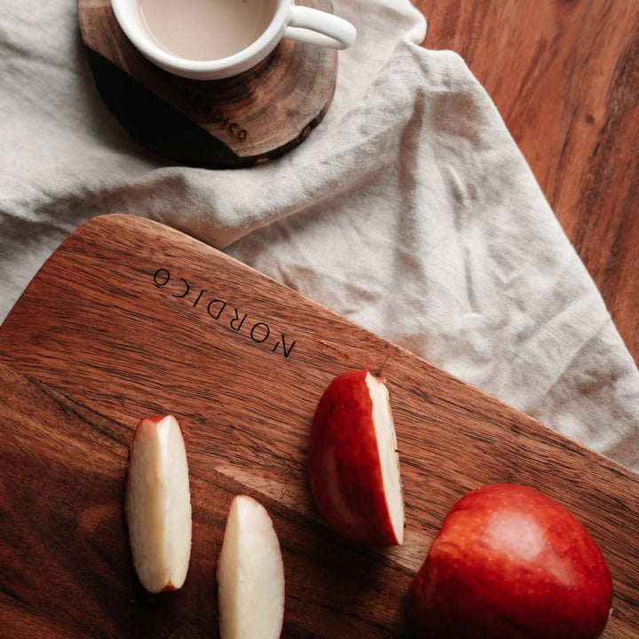 Close-up of Nordico acacia cutting board showcasing natural wood grain and smooth finish.