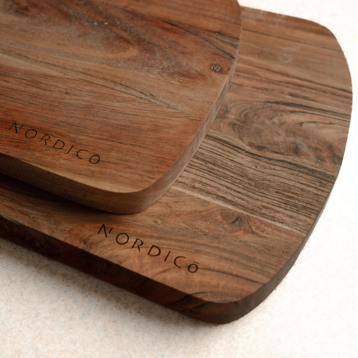 Side-by-side view of Nordico medium and large cutting boards with unique acacia wood grain patterns.