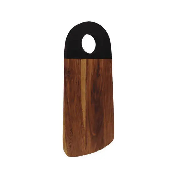 Standing Nordico medium acacia wood cutting board with black-painted handle and round ergonomic grip.