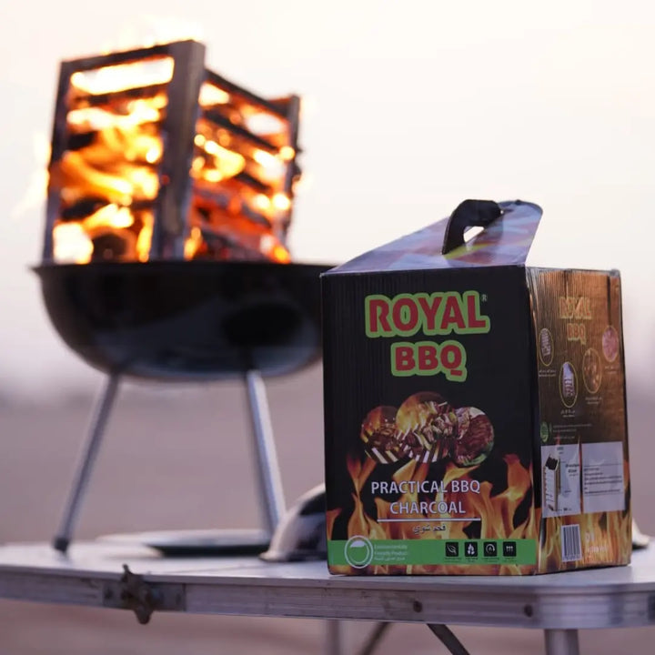 Royal BBQ Smart Box of Briquettes displayed next to a lit grill, perfect for hassle-free outdoor barbecues.